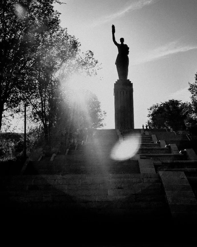 A statue silhouetted against the bright sun.